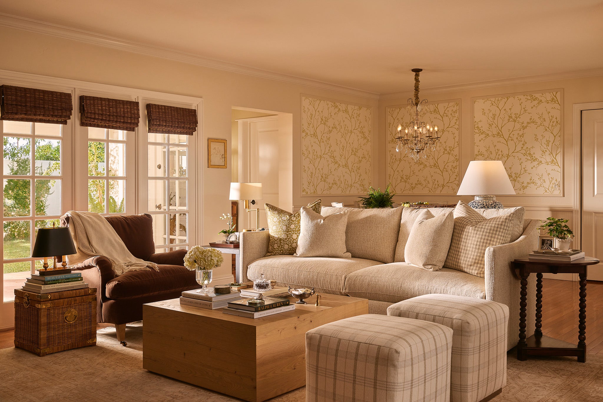 Rowe Serena Sofa in a light neutral fabric anchors a warm, traditional living room, styled with pillows, striped ottomans, and a wooden coffee table.