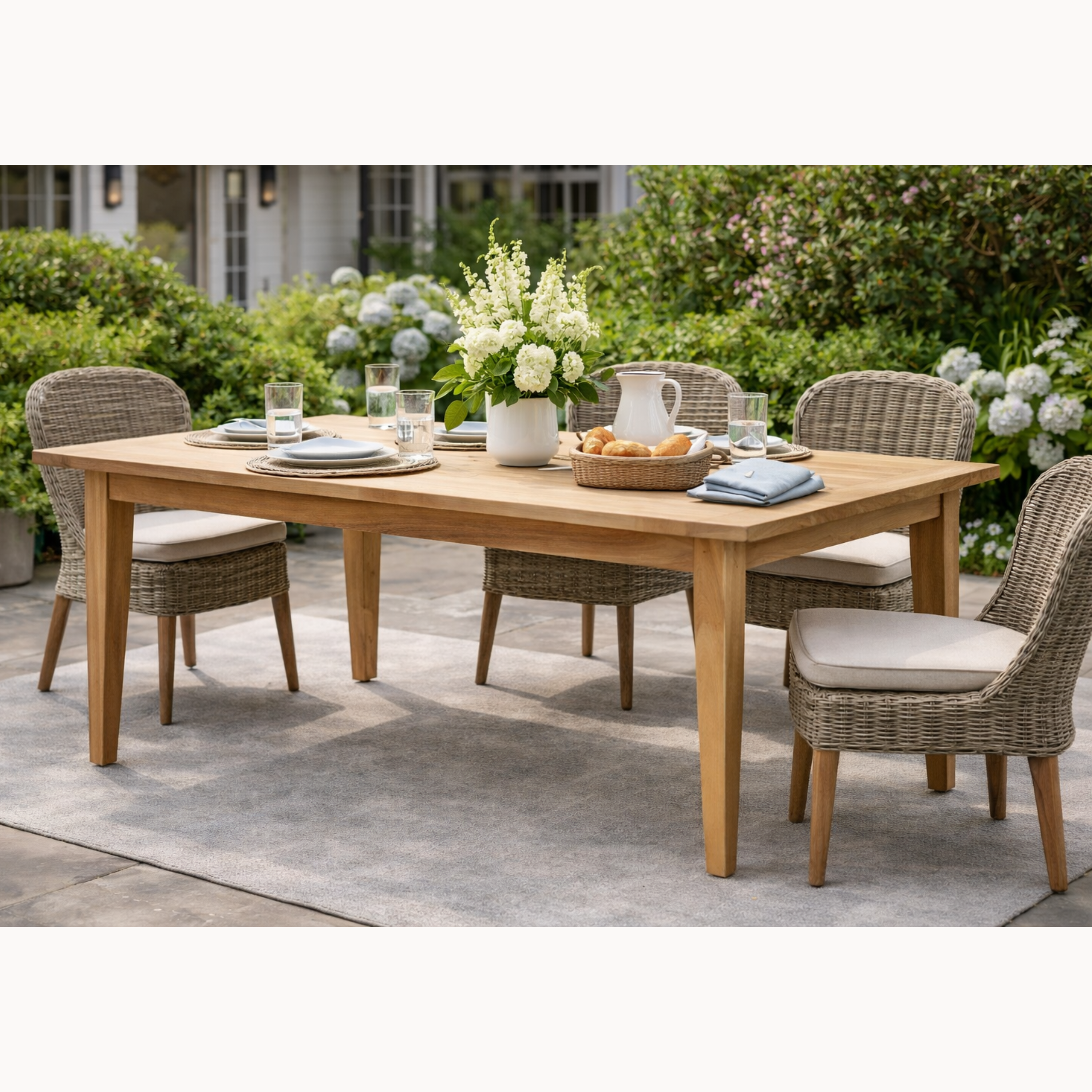 Outdoor dining table set with chairs in a garden setting