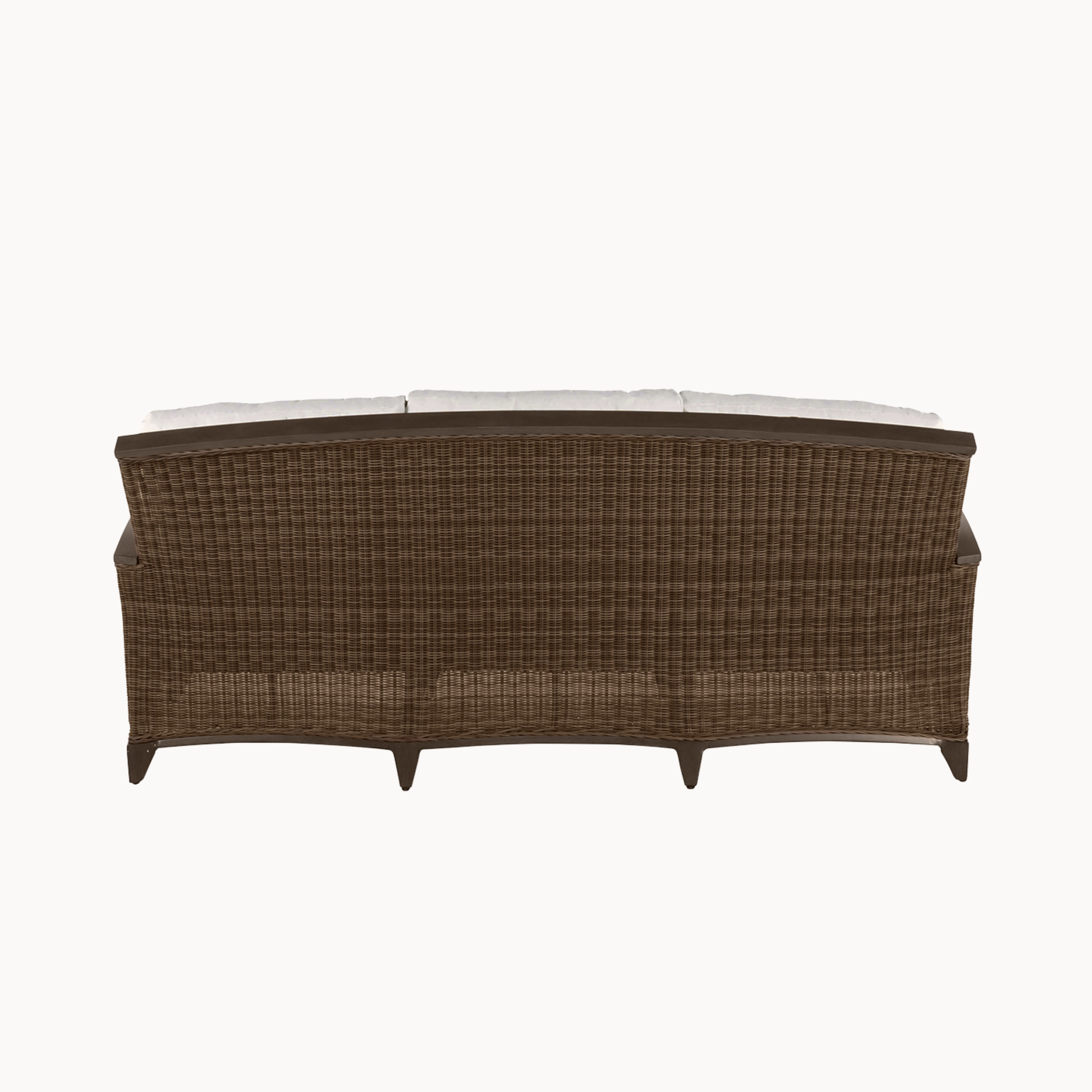 Brown wicker outdoor sofa with white cushions on a white background