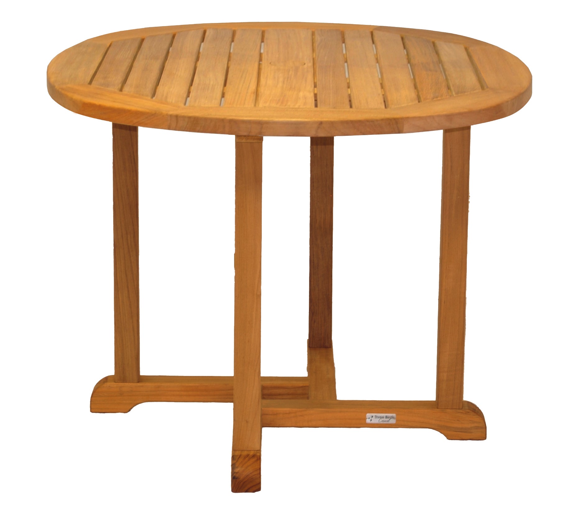 A Three Birds Oxford Teak Round 42" Dining Table set with four matching chairs on a stone patio, with greenery and a stone wall in the background.