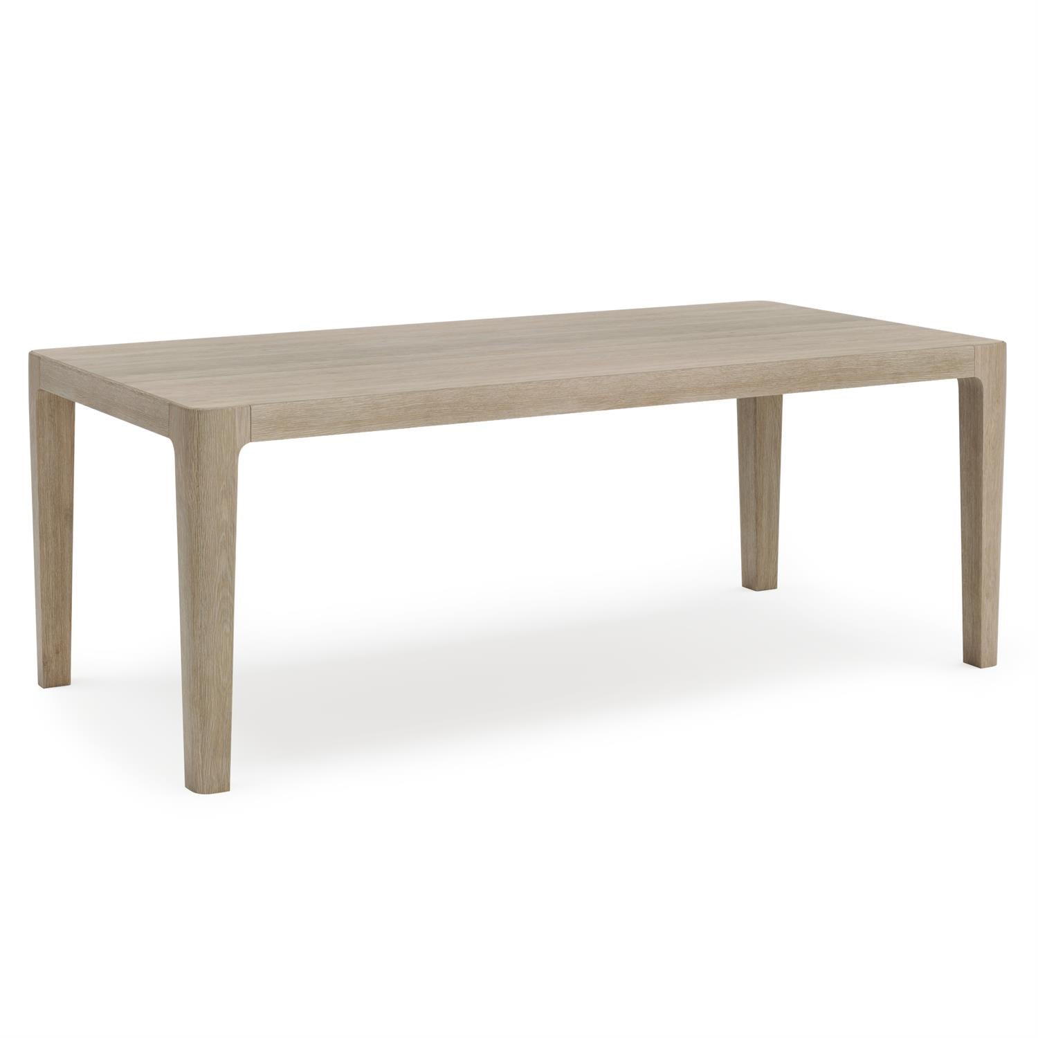 An angled perspective of the Edenton dining table, showcasing its sleek design, slatted teak top, and smooth, natural wood finish for an elegant outdoor dining experience.