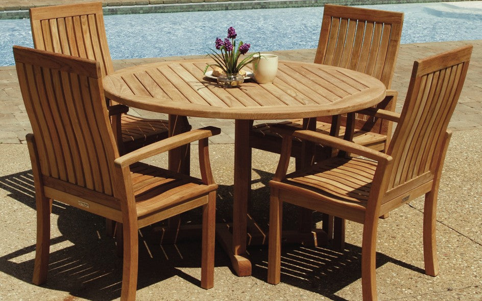 A 48-inch round outdoor dining set made of teak wood, featuring a table with a floral centerpiece and four armchairs with slatted backs and seats.