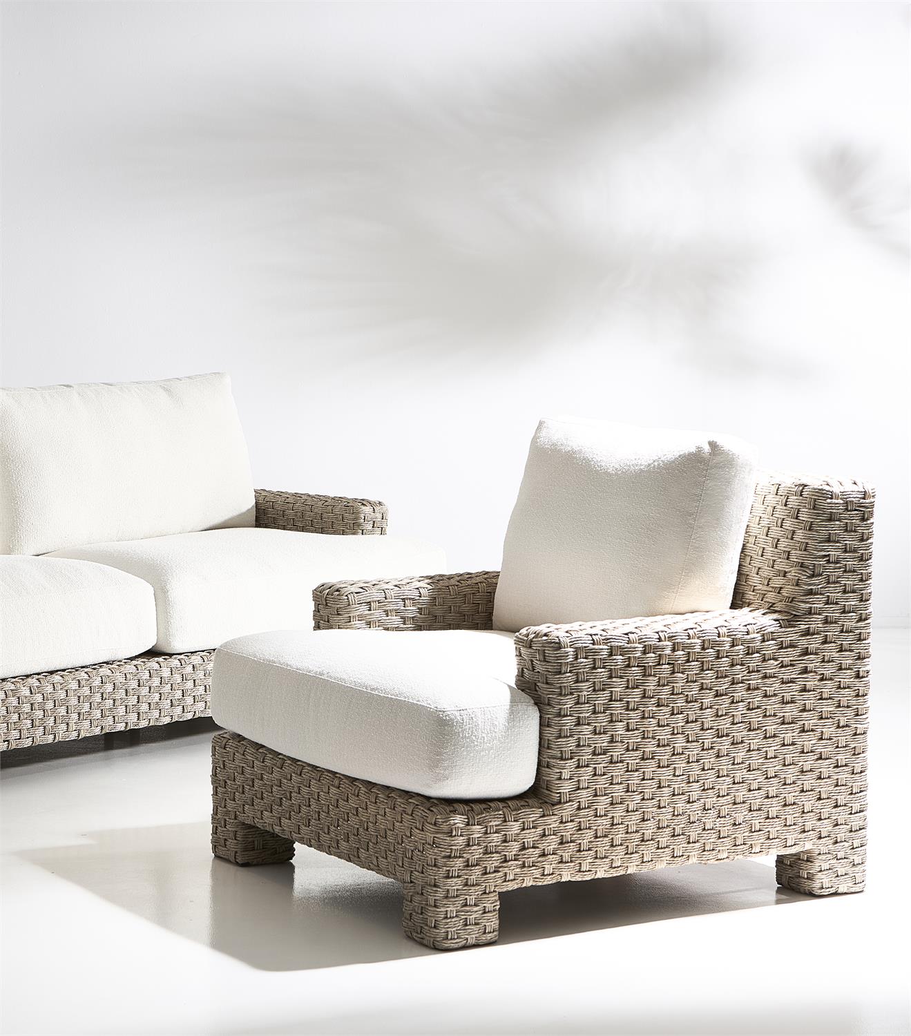 A close-up of the outdoor sofa’s T-shaped seat cushion and handwoven wicker frame. The thick, plush cushion is wrapped in weather-resistant fabric for durability, while the tightly woven wicker adds texture and a sophisticated, natural look.