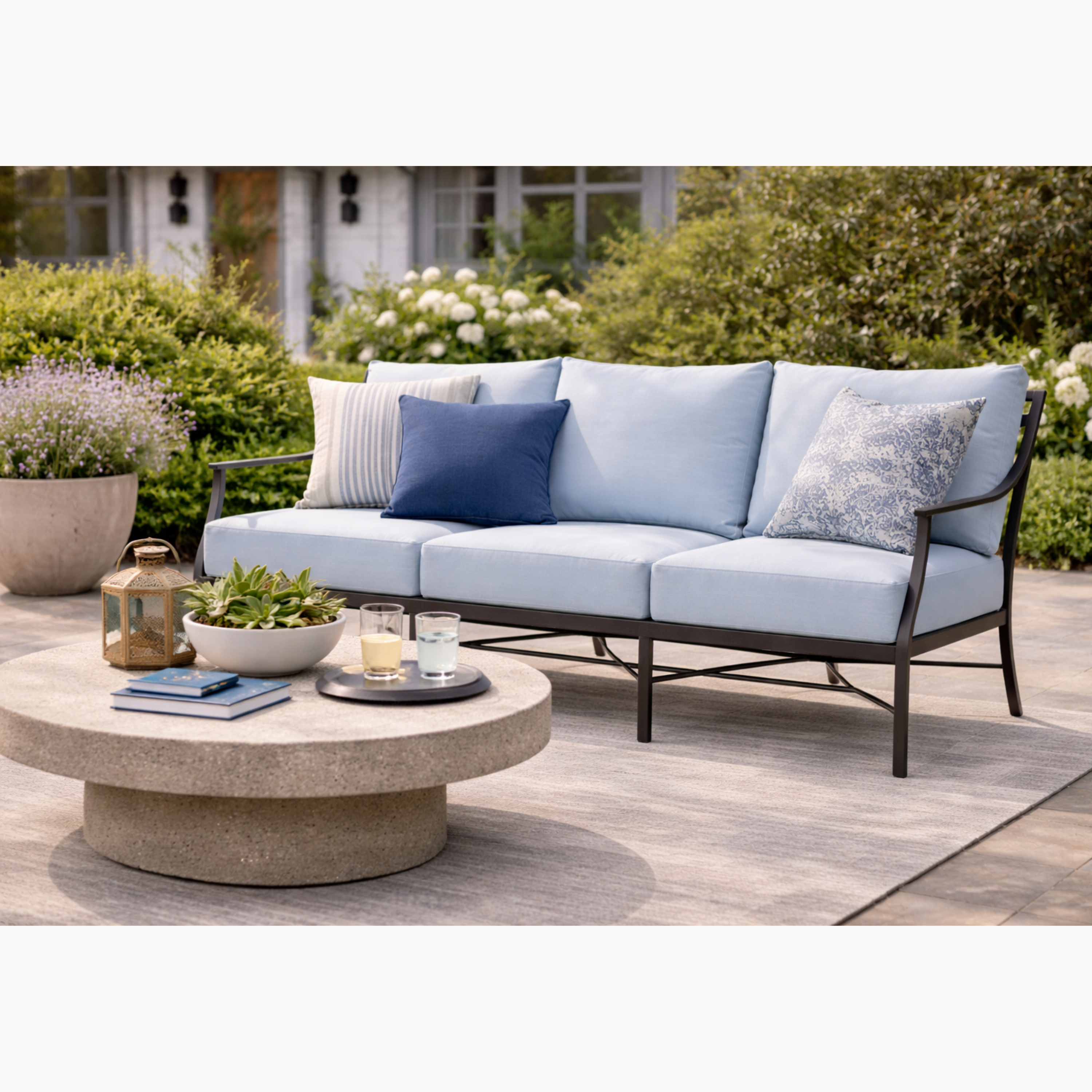 Outdoor patio set with light blue cushions and a round coffee table.
