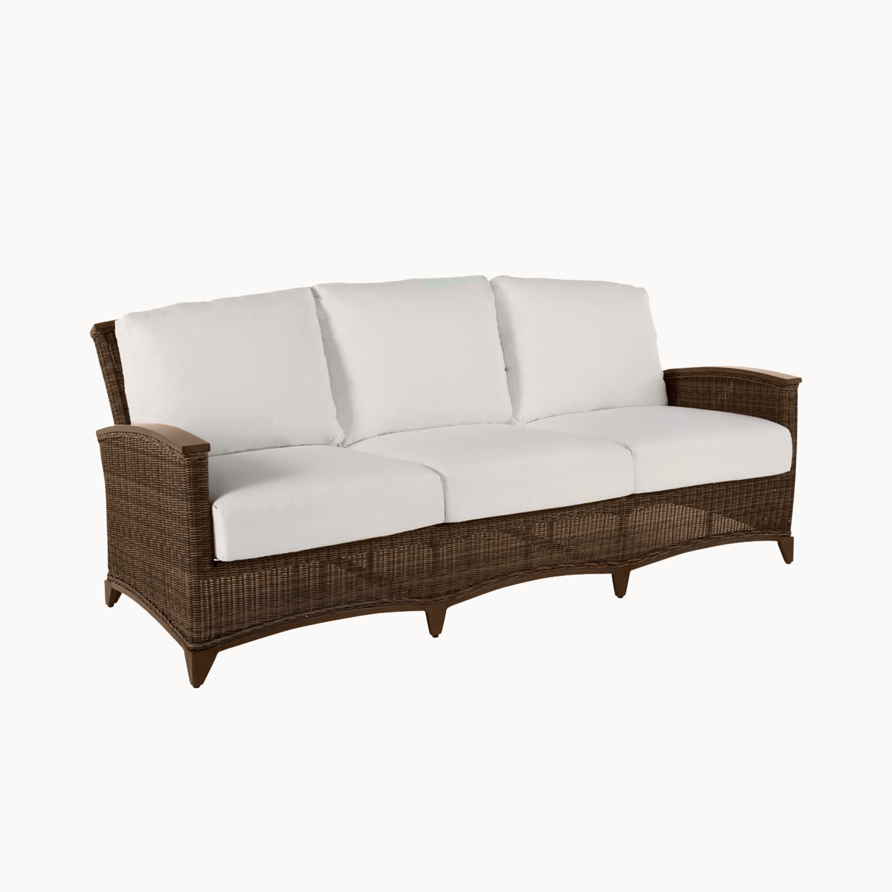 Wicker outdoor sofa with white cushions on a white background