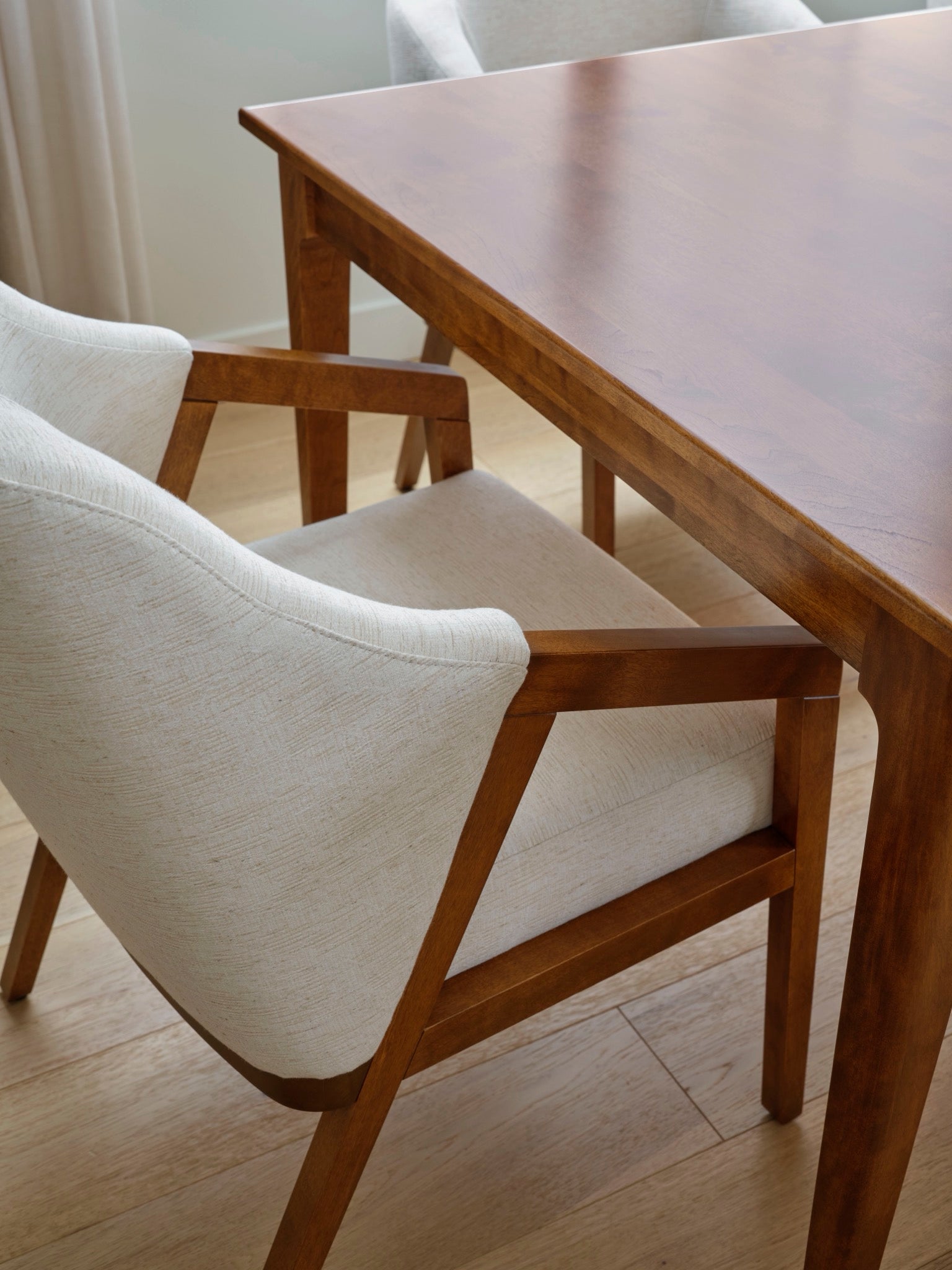 Close-up of a Canadel solid birch dining table and chair joinery