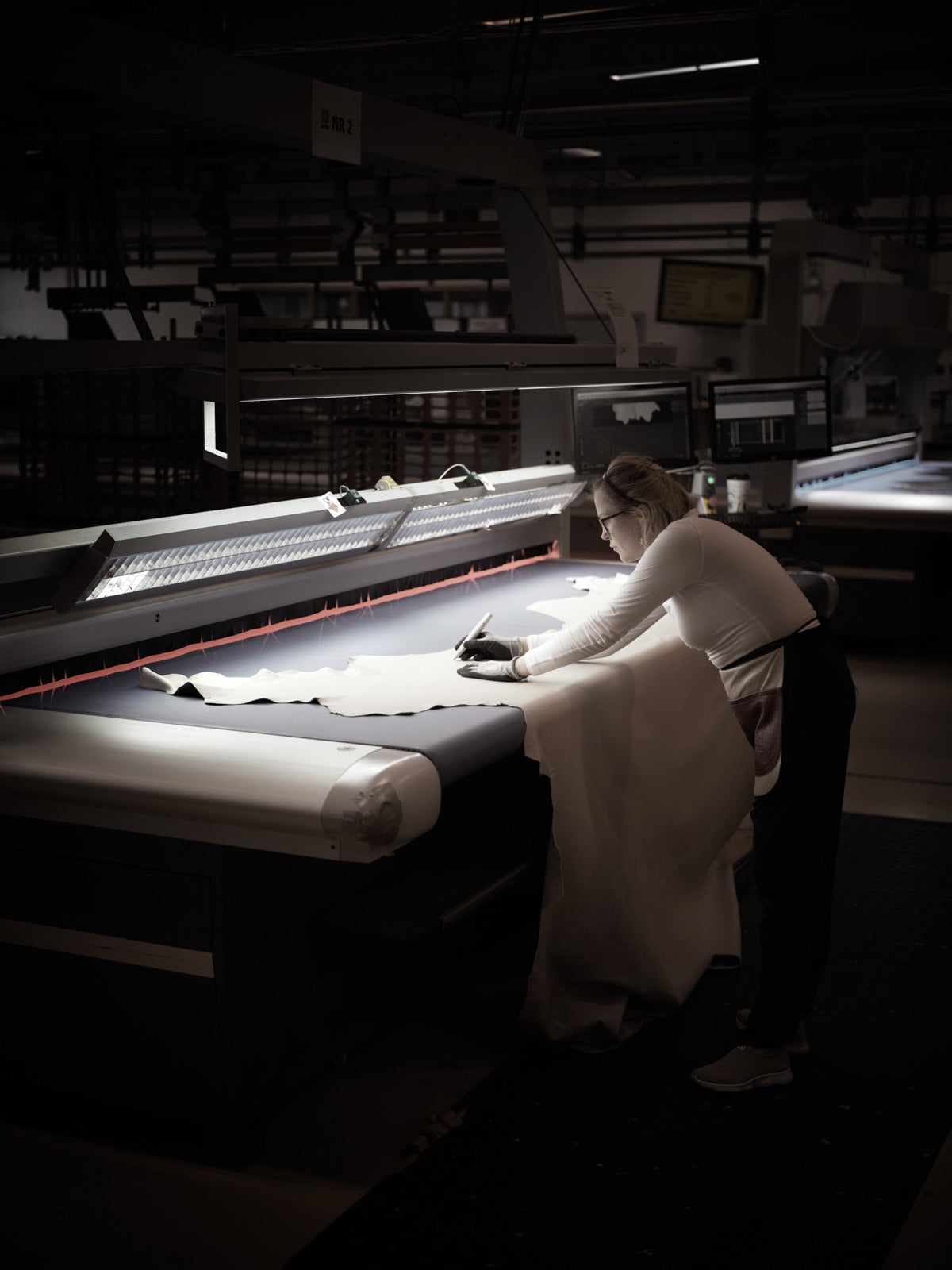 Ekornes artisan inspecting premium leather for Stressless furniture production